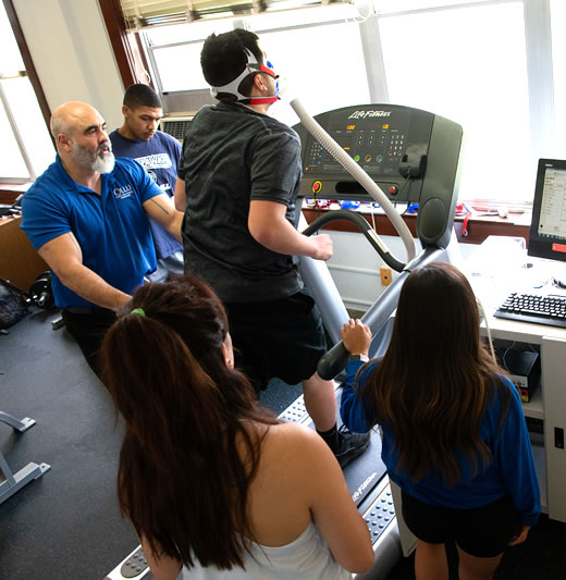 Profesor and students conducting testing during kinesiology lab session